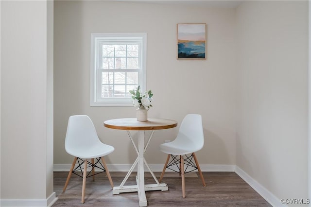 dining room featuring wood finished floors and baseboards