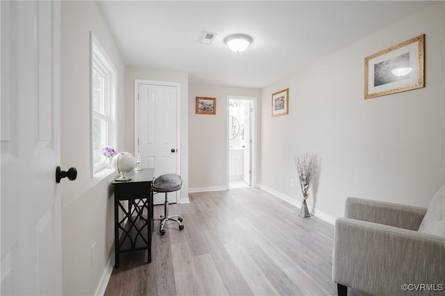 home office featuring baseboards, visible vents, and wood finished floors