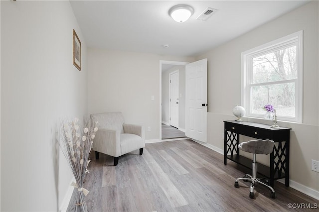 office area with visible vents, baseboards, and wood finished floors