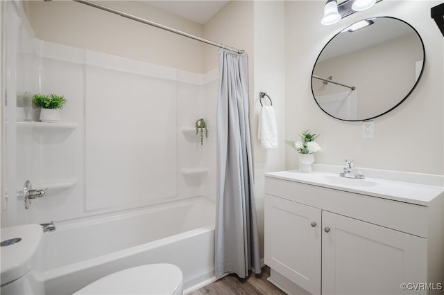 bathroom featuring vanity, shower / bath combo, wood finished floors, and toilet