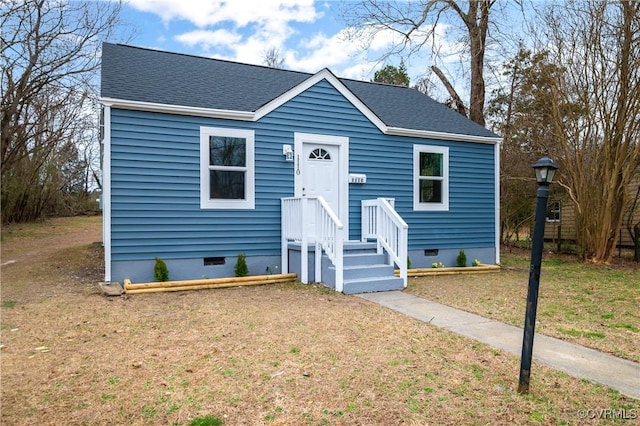 bungalow featuring a shingled roof, a front yard, and crawl space