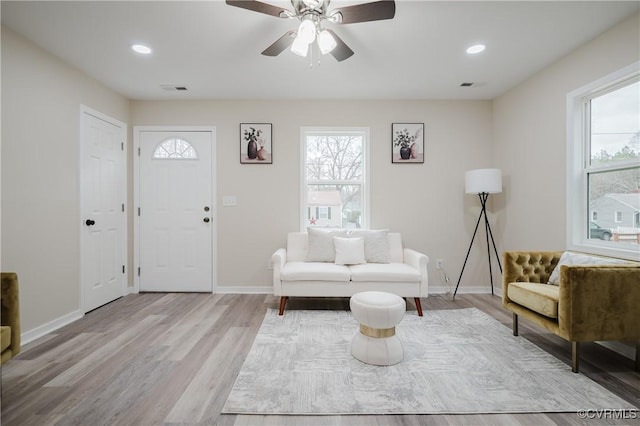 entryway with a wealth of natural light, visible vents, baseboards, and wood finished floors