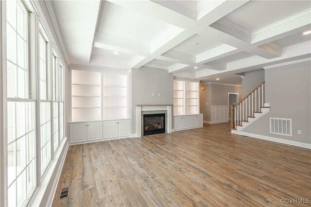 8383 Mount Eagle Rd, Hanover, VA 23005 - unfurnished living room with beamed ceiling, light wood finished floors, coffered ceiling, a glass covered fireplace, and ornamental molding