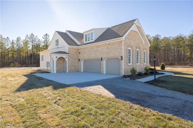 view of front of home featuring a garage, driveway, a front lawn, and brick siding