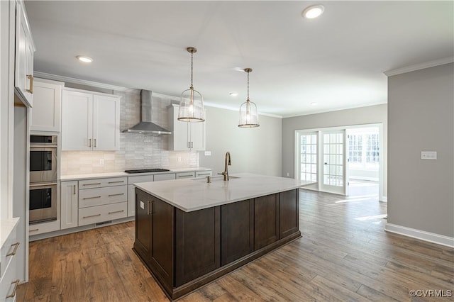 8383 Mount Eagle Rd, Hanover, VA 23005 - kitchen with wall chimney exhaust hood, a sink, ornamental molding, double oven, and black stovetop