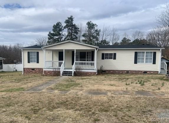 view of front of home featuring covered porch, a front lawn, and crawl space