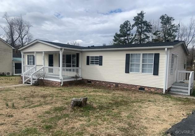 view of front facade with covered porch, a front lawn, and crawl space