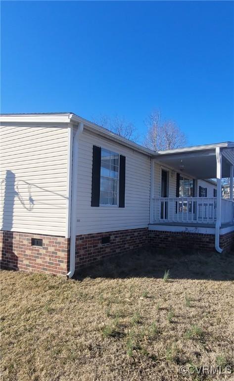 view of property exterior featuring crawl space and a lawn