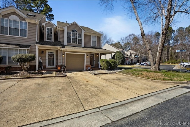 view of front of property featuring a garage, driveway, and brick siding