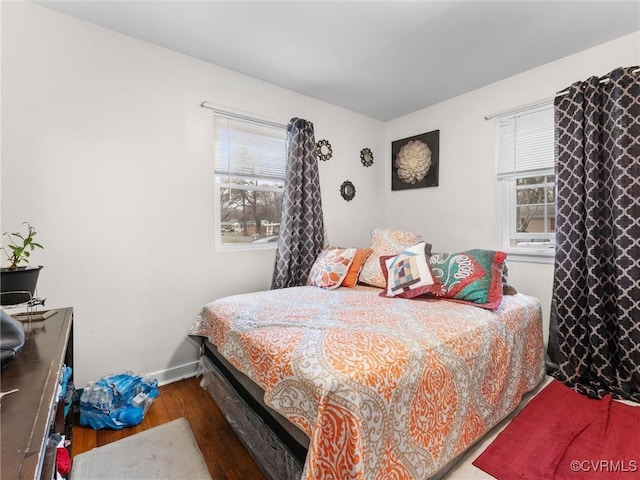 bedroom featuring baseboards and wood finished floors