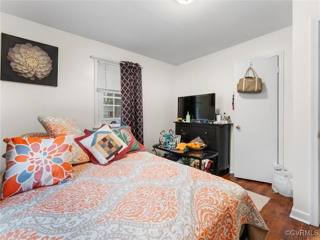 bedroom featuring dark wood-style floors