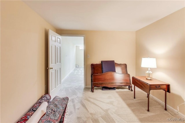 sitting room with carpet and baseboards