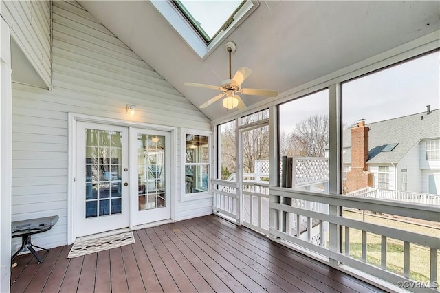 sunroom / solarium featuring a ceiling fan and vaulted ceiling with skylight