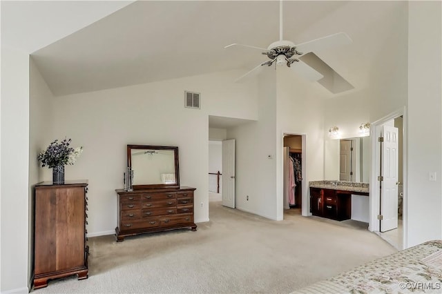 bedroom with light carpet, visible vents, a ceiling fan, a walk in closet, and high vaulted ceiling