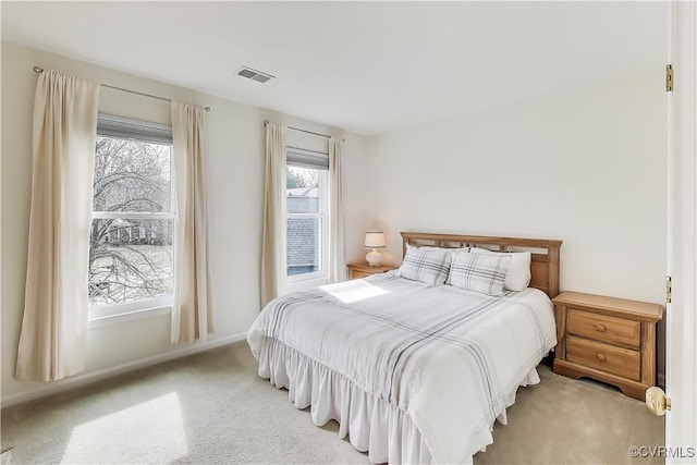 carpeted bedroom with visible vents and baseboards