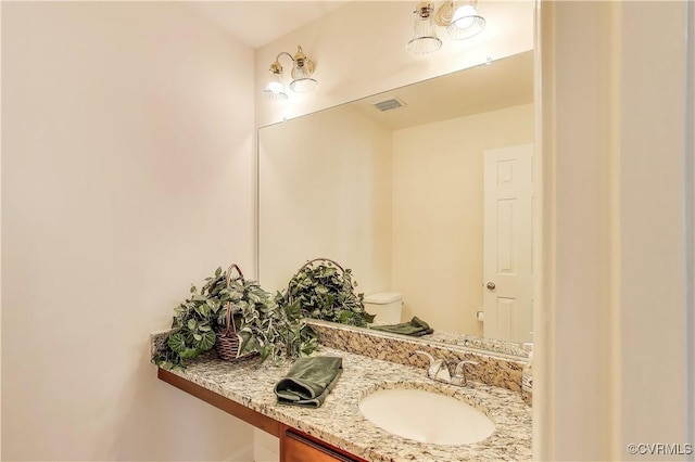 half bathroom with visible vents and vanity