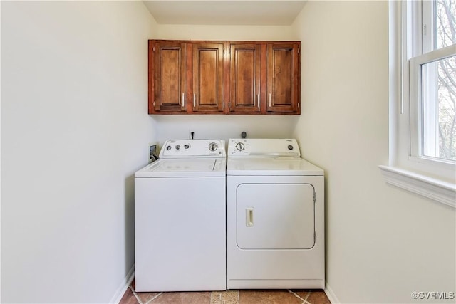 laundry room with washer and dryer, cabinet space, and baseboards