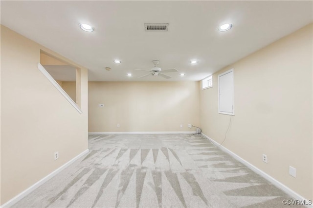 below grade area with baseboards, a ceiling fan, light colored carpet, and recessed lighting