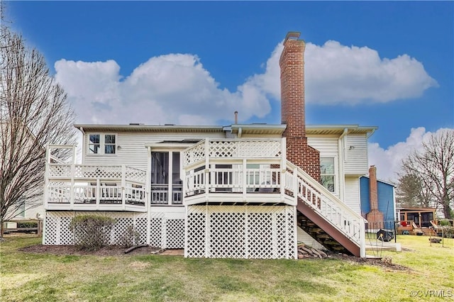 rear view of property with a deck and a yard