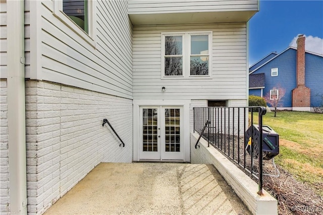 back of house with a yard, a patio, and brick siding