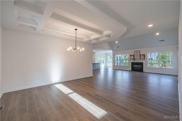 unfurnished living room featuring baseboards, coffered ceiling, a glass covered fireplace, dark wood-type flooring, and a chandelier