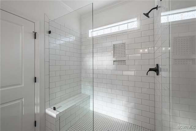 bathroom featuring plenty of natural light, tiled shower, and crown molding