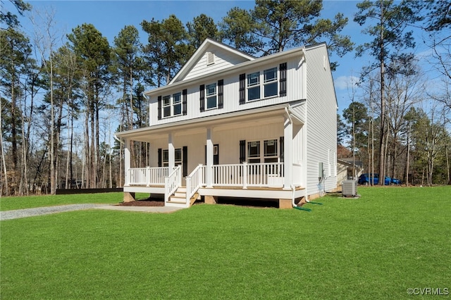 view of front of house with covered porch, cooling unit, and a front yard