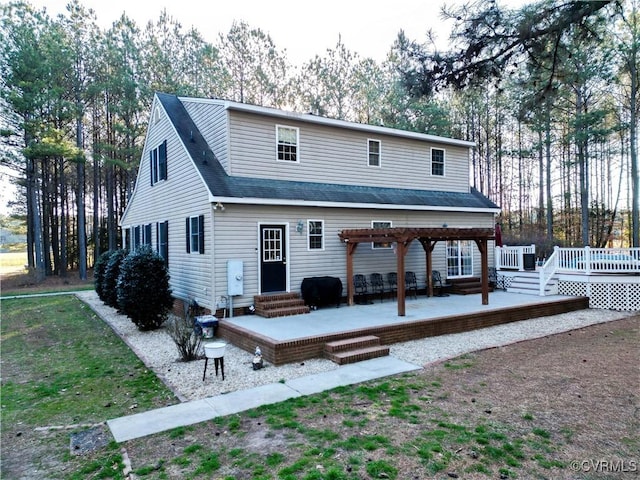 rear view of house with entry steps, a wooden deck, roof with shingles, and a pergola