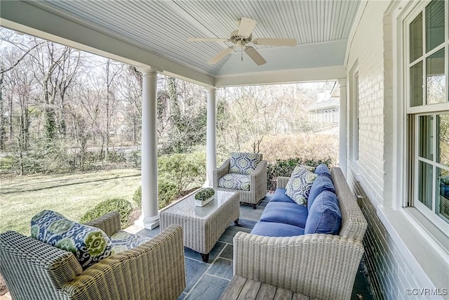 sunroom / solarium with plenty of natural light and a ceiling fan