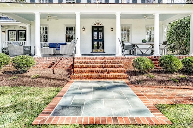 entrance to property with covered porch and a ceiling fan