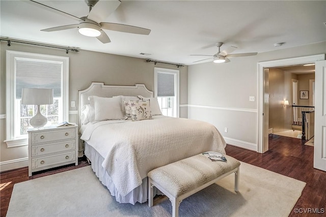 bedroom with ceiling fan, baseboards, and wood finished floors