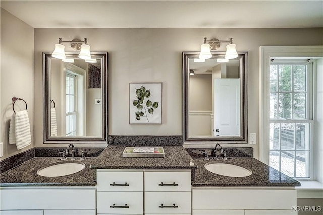 full bath with double vanity and a sink