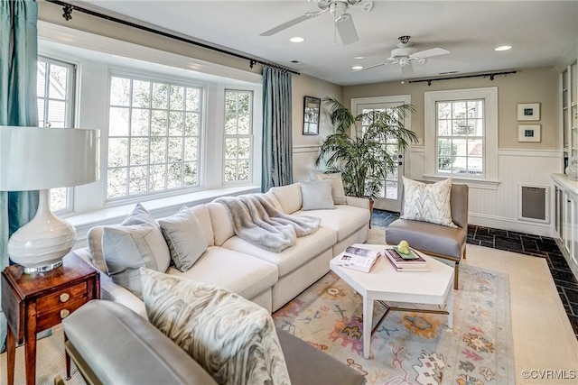 living area featuring recessed lighting and wainscoting