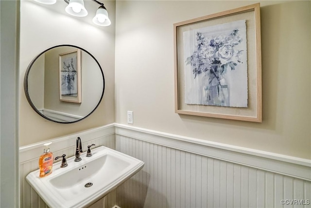 bathroom with wainscoting and a sink