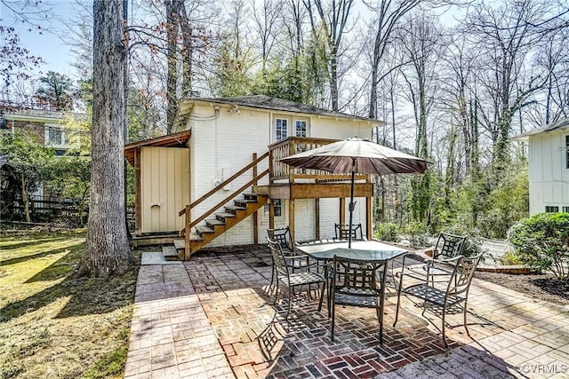 view of patio featuring outdoor dining space and stairs