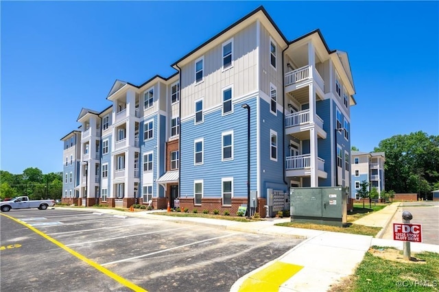 view of building exterior with uncovered parking