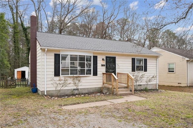 view of front facade featuring crawl space, a chimney, fence, and roof with shingles