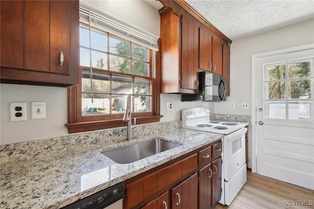 kitchen with white electric range oven, a healthy amount of sunlight, a sink, a textured ceiling, and black microwave