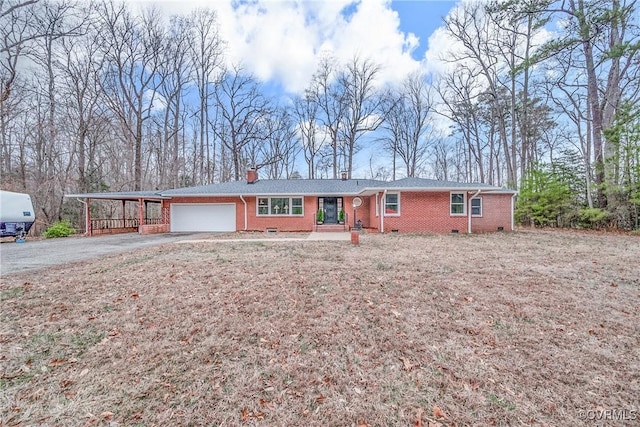 single story home with brick siding, a carport, aphalt driveway, crawl space, and an attached garage