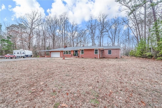 single story home featuring crawl space, brick siding, a chimney, and an attached garage