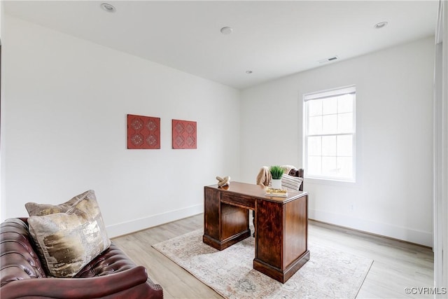 office space with light wood finished floors, recessed lighting, visible vents, and baseboards