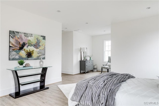 bedroom with light wood-style flooring and baseboards