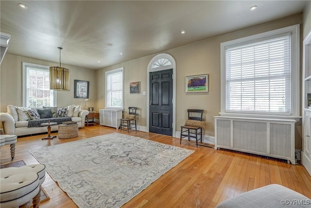 entrance foyer featuring radiator, hardwood / wood-style flooring, baseboards, and recessed lighting