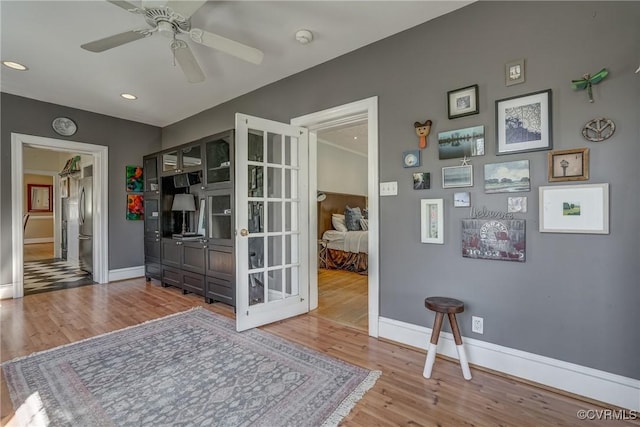 interior space with recessed lighting, wood finished floors, and baseboards