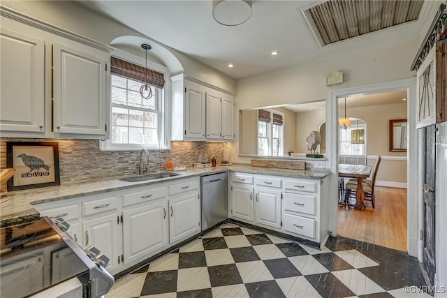 kitchen featuring dishwasher, plenty of natural light, a sink, and visible vents