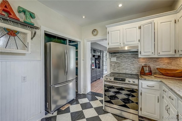 kitchen with under cabinet range hood, dark floors, white cabinetry, and stainless steel appliances