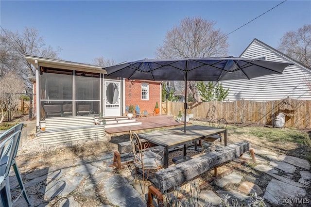 view of patio / terrace with a sunroom, fence, and a deck