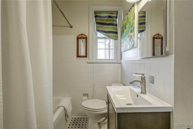 full bath with toilet, shower / tub combo with curtain, tile patterned floors, vanity, and tile walls