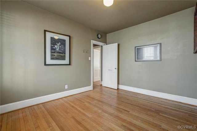 empty room featuring light wood-style floors and baseboards