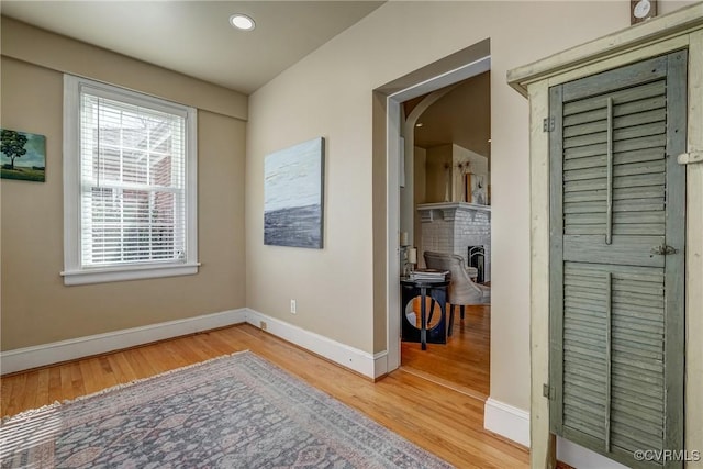 interior space featuring recessed lighting, wood finished floors, and baseboards